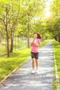 Young asian woman jogging during Outdoor Workout in a Park. Royalty Free Stock Photo