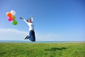 Young asian woman jumping with colored balloons Royalty Free Stock Photo