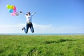 Young asian woman jumping with colored balloons Royalty Free Stock Photo