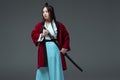 young asian woman in kimono holding katana sword and looking at camera Royalty Free Stock Photo