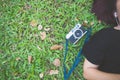 Young Asian woman laying on the green grass listening to music in the park with a chill emotion. Royalty Free Stock Photo