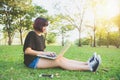 Distance learning concept. Happy hipster young asian woman working on laptop in park. Student studying outdoors. Royalty Free Stock Photo