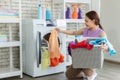 Young Asian woman loading the laundry Royalty Free Stock Photo