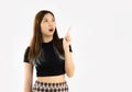 Young asian woman long hair in black crop t-shirt posing finger pointing for your copy space text on white background Royalty Free Stock Photo