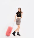 Young asian woman long hair in black crop top t-shirt with pink luggage to travelling on white background. travel concept Royalty Free Stock Photo