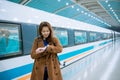 Young asian woman looking her watch while checking time for the train Royalty Free Stock Photo