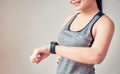 Young asian woman looking the sports watch and checking her performance after exercise at the home. Royalty Free Stock Photo