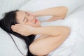 Young asian woman lying on bed pain headache in the bedroom at home, unhappy female exhaustion and sick headache. Royalty Free Stock Photo