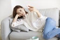 Young asian woman lying on sofa taking a selfie using mobile phone Royalty Free Stock Photo