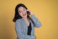 Young asian woman making a call using a cell phone Royalty Free Stock Photo