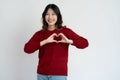 Young Asian woman making head portrait with hands on white background Royalty Free Stock Photo