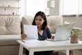 Young Asian woman manage family finances using laptop Royalty Free Stock Photo