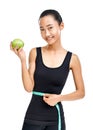 Young Asian woman measuring her waist and holding green apple Royalty Free Stock Photo