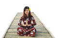 Young Asian woman meditating on the bamboo bridge Royalty Free Stock Photo