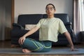 Young asian woman doing the tevolved easy pose or easy seated twist. Royalty Free Stock Photo