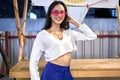 Young asian woman in modern dress and pink glasses at a night urban fair