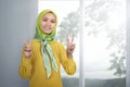 Young asian woman muslim giving peace sign Royalty Free Stock Photo