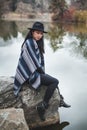 Asian model sitting on a rock staying warm Royalty Free Stock Photo