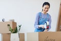 Young Asian Woman Packing Boxes for Moving Royalty Free Stock Photo