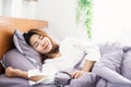 Young Asian woman peacefully sleeping well on comfortable soft bed