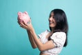 Young Asian woman with a pig coin bank Royalty Free Stock Photo