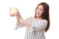 Young Asian woman with a pig coin bank. Royalty Free Stock Photo