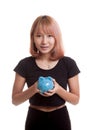 Young Asian woman with a pig coin bank. Royalty Free Stock Photo