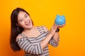 Young Asian woman with a pig coin bank. Royalty Free Stock Photo