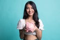 Young Asian woman with a pig coin bank Royalty Free Stock Photo