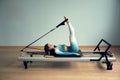 Young asian woman pilates stretching sport in reformer bed instructor girl in a studio Royalty Free Stock Photo