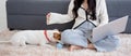 Young asian woman playful with fluffy dog for relax with love in the living room at home,.