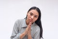 A young asian woman pleads for help, pressuring and making you feel guilty.  on a white background Royalty Free Stock Photo