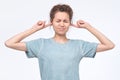 Woman plugging ears, pretending not to hear what she is told.