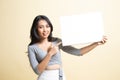 Young Asian woman point to  blank sign Royalty Free Stock Photo