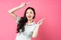 Young asian woman pointing upwards with cheerful face Royalty Free Stock Photo