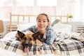 Young Asian Woman Posing with Dog on Bed Royalty Free Stock Photo