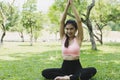 Young asian woman practicing yoga outdoors in morning park. Concept of healthy lifestyle Royalty Free Stock Photo