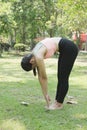 Young asian woman practicing yoga outdoors in morning park. Concept of healthy lifestyle Royalty Free Stock Photo