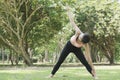 Young asian woman practicing yoga outdoors in morning park. Concept of healthy lifestyle Royalty Free Stock Photo