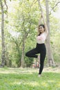 Young asian woman practicing yoga outdoors in morning park. Concept of healthy lifestyle Royalty Free Stock Photo