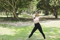 Young asian woman practicing yoga outdoors in morning park. Concept of healthy lifestyle Royalty Free Stock Photo