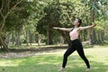 Young asian woman practicing yoga outdoors in morning park. Concept of healthy lifestyle Royalty Free Stock Photo