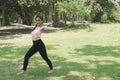 Young asian woman practicing yoga outdoors in morning park. Concept of healthy lifestyle Royalty Free Stock Photo