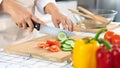 Young Asian woman is preparing healthy food vegetable salad by Cutting cucumber for ingredients on cutting board on light kitchen Royalty Free Stock Photo