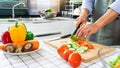 Young Asian woman is preparing healthy food vegetable salad by Cutting ingredients on cutting board on light kitchen, Cooking At Royalty Free Stock Photo