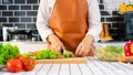 Young Asian woman is preparing healthy food vegetable salad by Cutting ingredients on cutting board on light kitchen, Cooking At Royalty Free Stock Photo