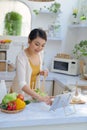 Young asian woman  preparing vegetables for salad at her kitchen Royalty Free Stock Photo