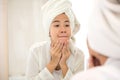 Young asian woman pressing her face, trying remove acne Royalty Free Stock Photo