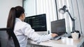 Young Asian woman Programmer Typing code working with computer at table, coding cyberspace and Web Development Concept Royalty Free Stock Photo