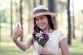 Young asian woman put on hat and holding flower Royalty Free Stock Photo